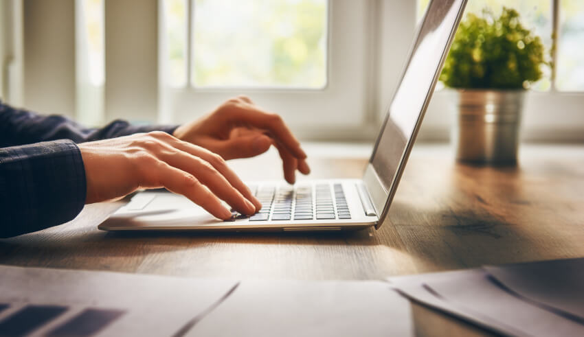 Person typing laptop technology